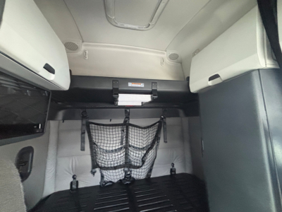 Truck sleeper cab storage area with wall nets and overhead compartments in a Freightliner CA-126