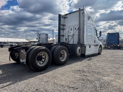 Freightliner CA-126 tractor from rear-left side showing sleeper cab, dual rear axles, and fifth wheel with tires.