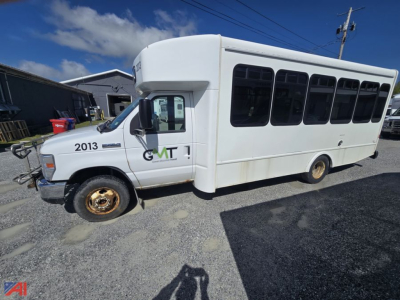 Ford E450 shuttle bus side view showing wheelchair-accessible bus with large windows and white body, wheel rims, and GVWR markings.