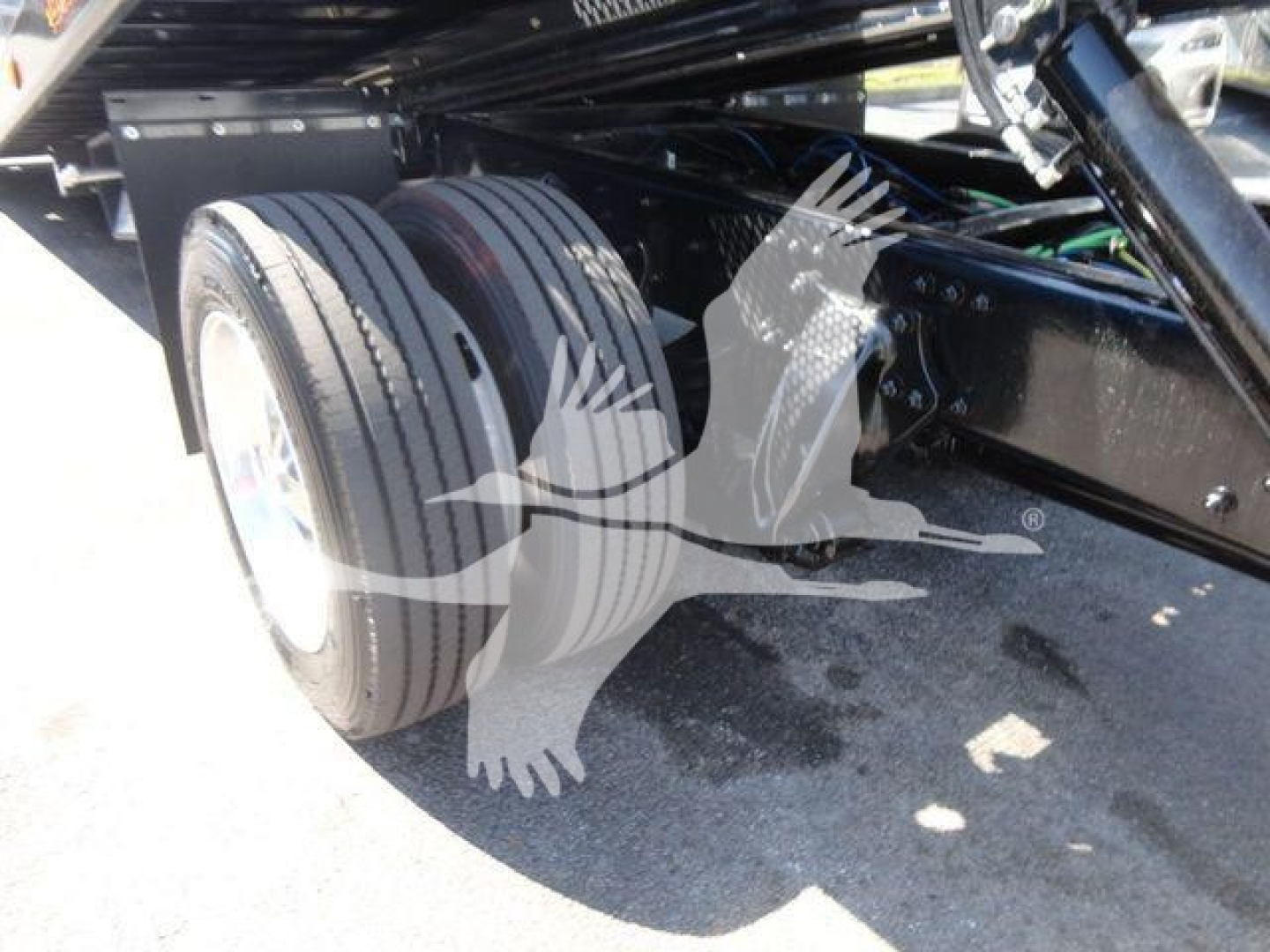 Freightliner M2 106 rollback truck rear wheel assembly showing dual rear tires and undercarriage components.