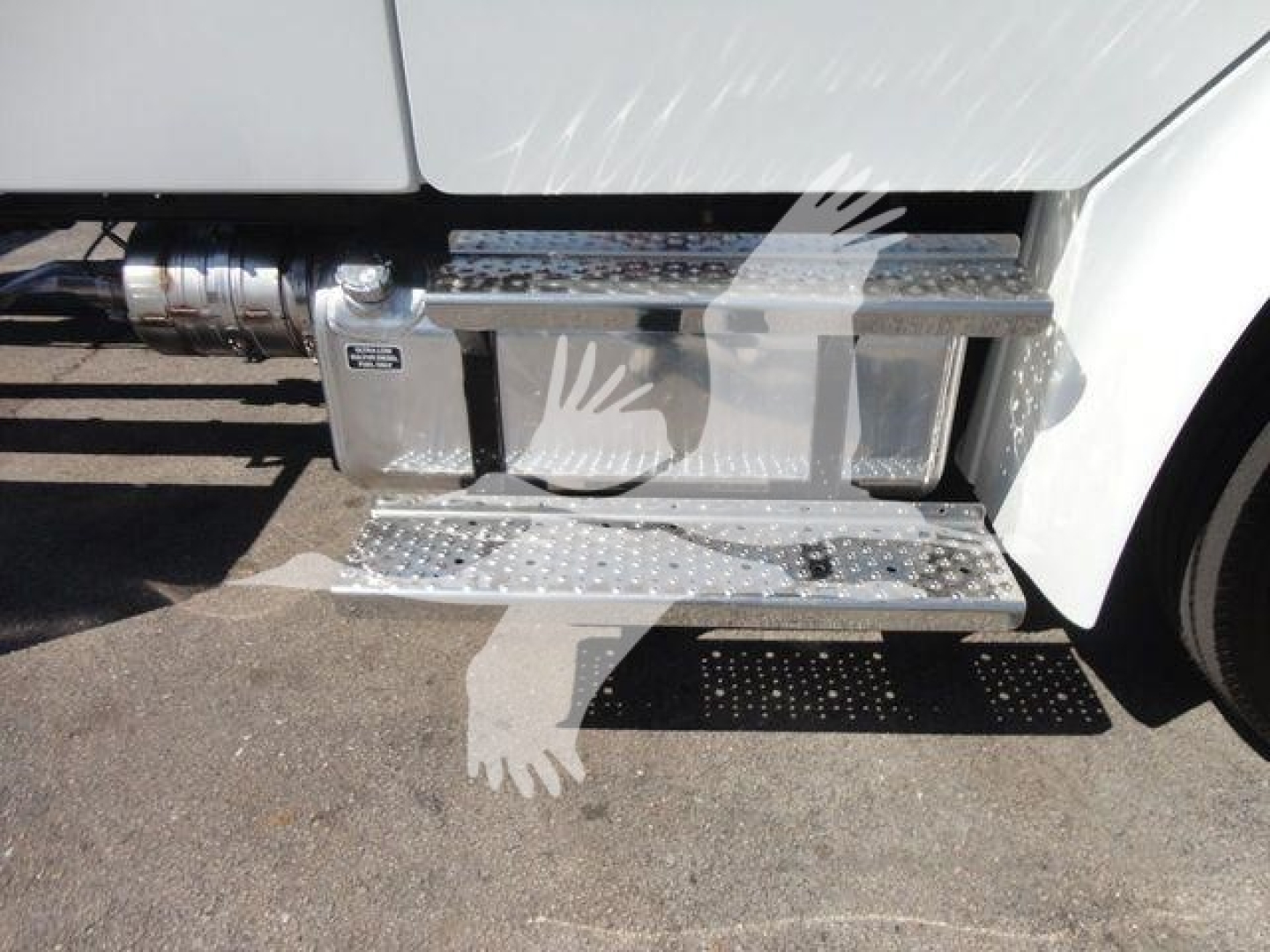 Truck side step with chrome diamond plate running board and door scuff area near fuel cap on Freightliner M2 106 cab chassis.