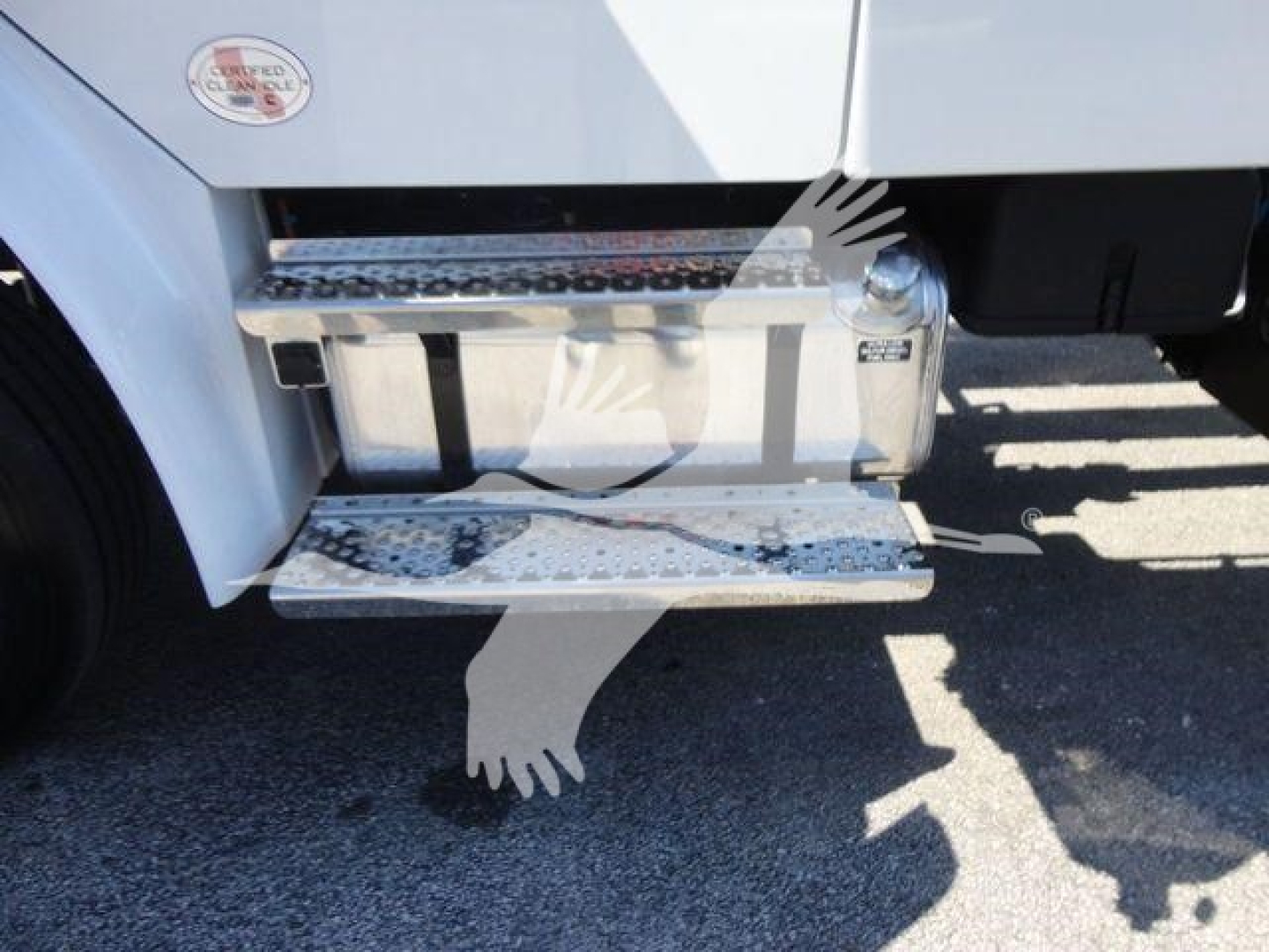 Freightliner M2 106 side step with chrome running board and fuel tank visible