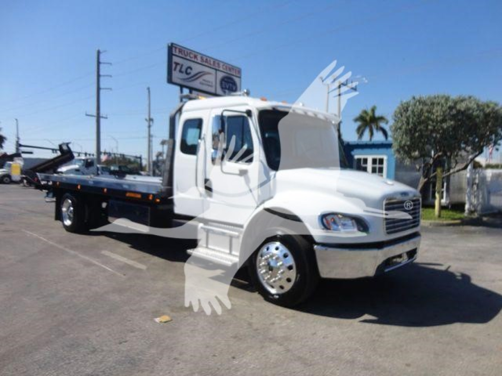 Freightliner M2 106 rollback tow truck side view showing flatbed, cab, and chrome wheels.
