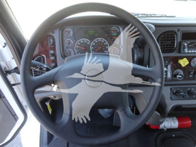 Dashboard and steering wheel view of a Freightliner M2 106 cab interior with gauges, steering wheel, and controls visible.