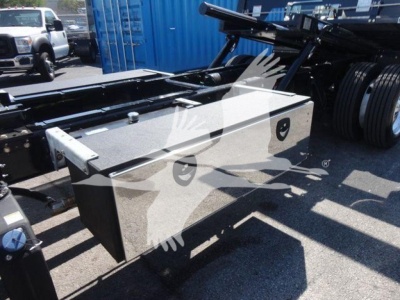 Freightliner M2 106 chassis with aluminum toolbox mounted on frame showing storage box and part of roll-back setup.
