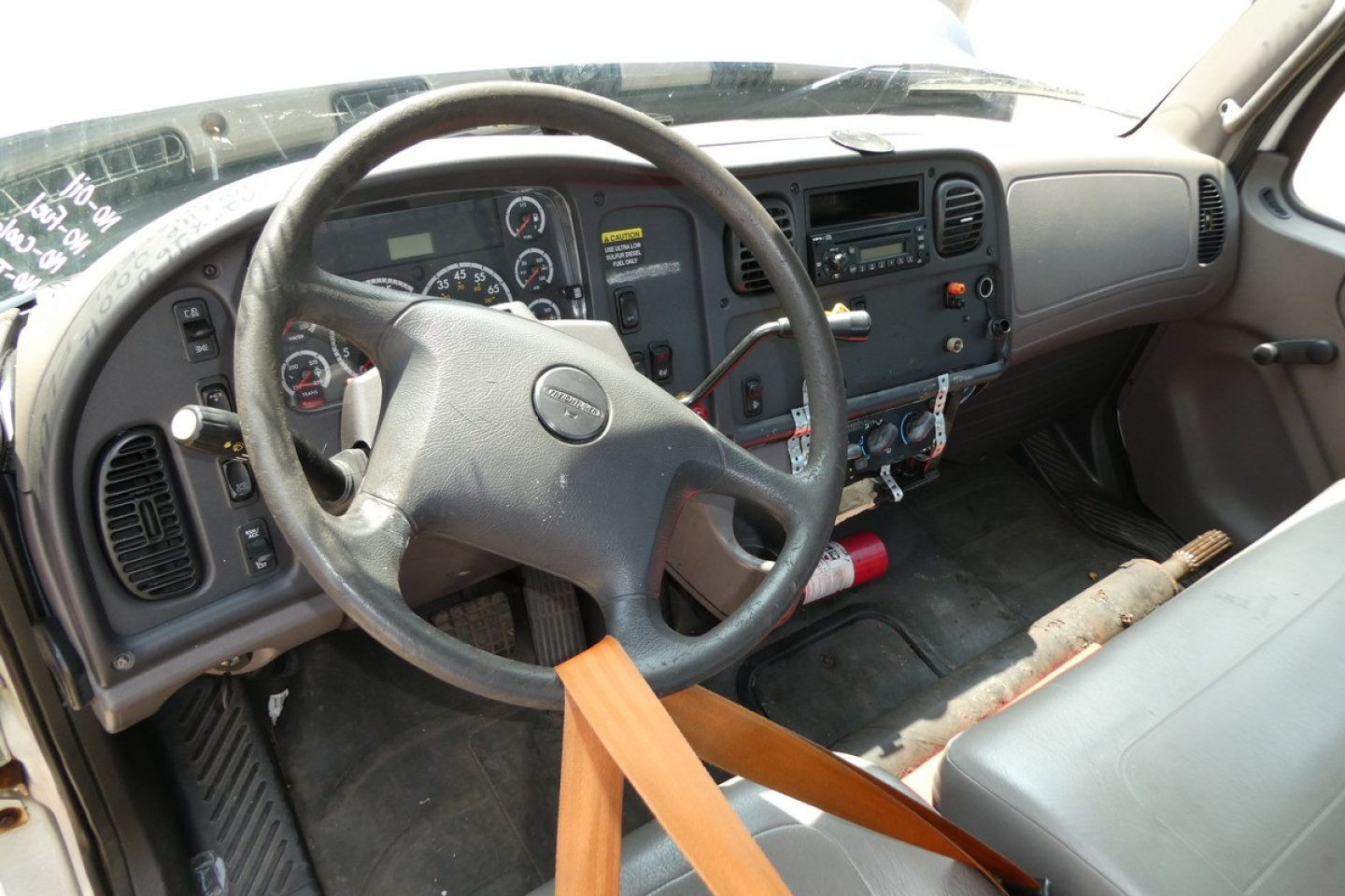 Truck cab interior of a 2008 Freightliner M2-106 showing steering wheel, dashboard gauges, and center console