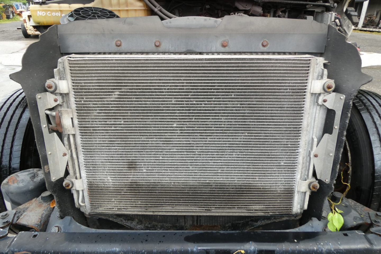 Freightliner M2-106 truck radiator visible in front, with surrounding bumper and engine bay components