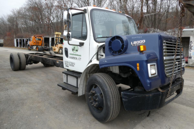 2008 Freightliner M2-106 chassis cab with mounted 48,000 lb boom, box truck body, front grille and headlights visible; white cab with green company logo; VIN and stock number not visible on image surface.