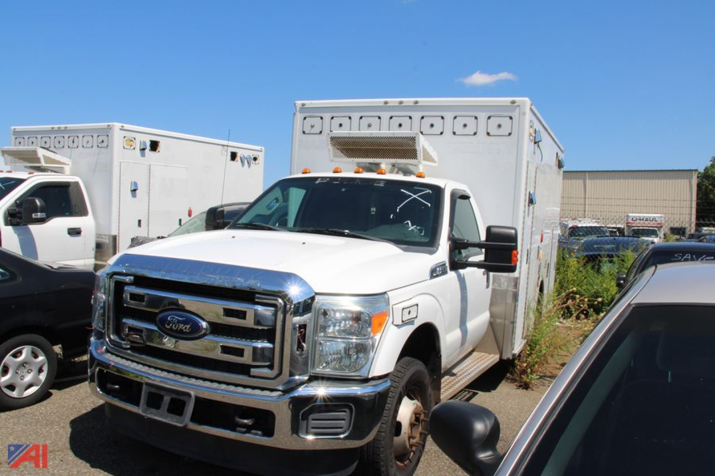 Ford F-350 Super Duty ambulance front view with box rear showing chrome grille and warning lights.