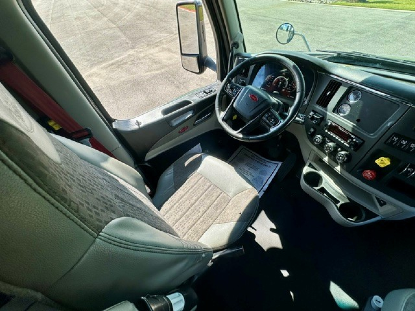 Driver cabin of a Peterbilt 579 truck interior with steering wheel, dashboard, and center console visible.