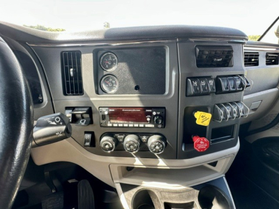 Peterbilt 579 truck dashboard showing gauges, control switches, and radio panel in a sleeper cab.