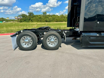 Peterbilt 579 tractor rear axle and frame with dual rear wheels and black sleeper cab visible