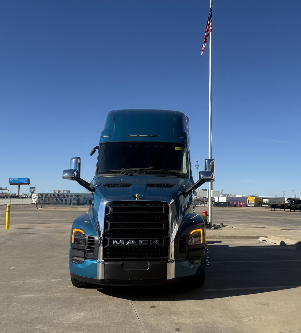 Front view of a blue 2026 Mack PR64T76H conventional sleeper truck showing bold grille and headlights.