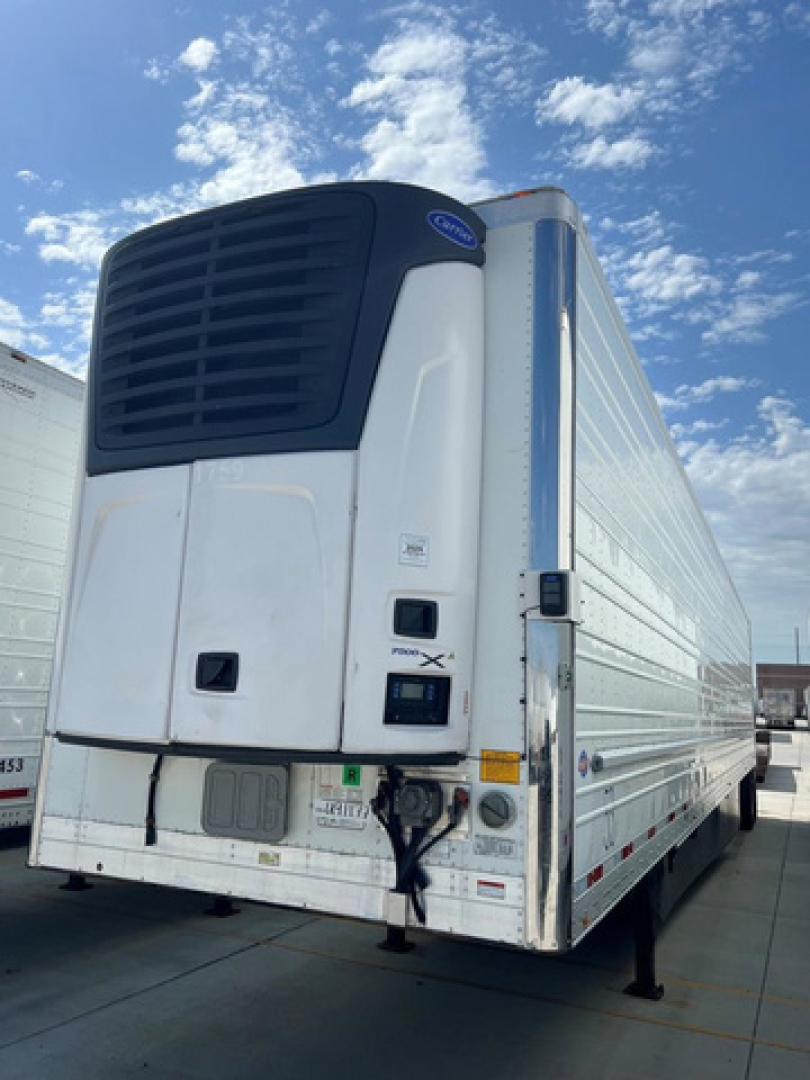 Refrigerated trailer with Carrier unit on front, rear view showing doors and cooling system.