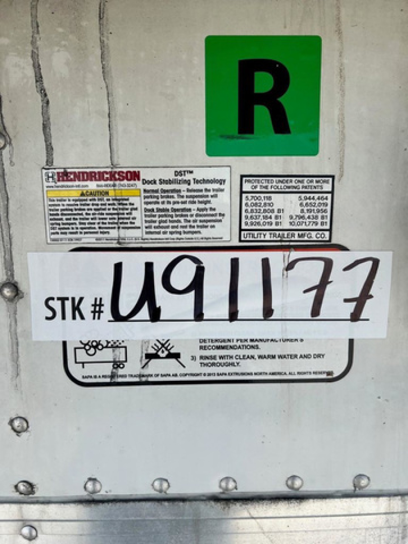 Reefer trailer rear showing stock number sticker STK# U91177, R green badge, and Warnick/Hendrickson labels.