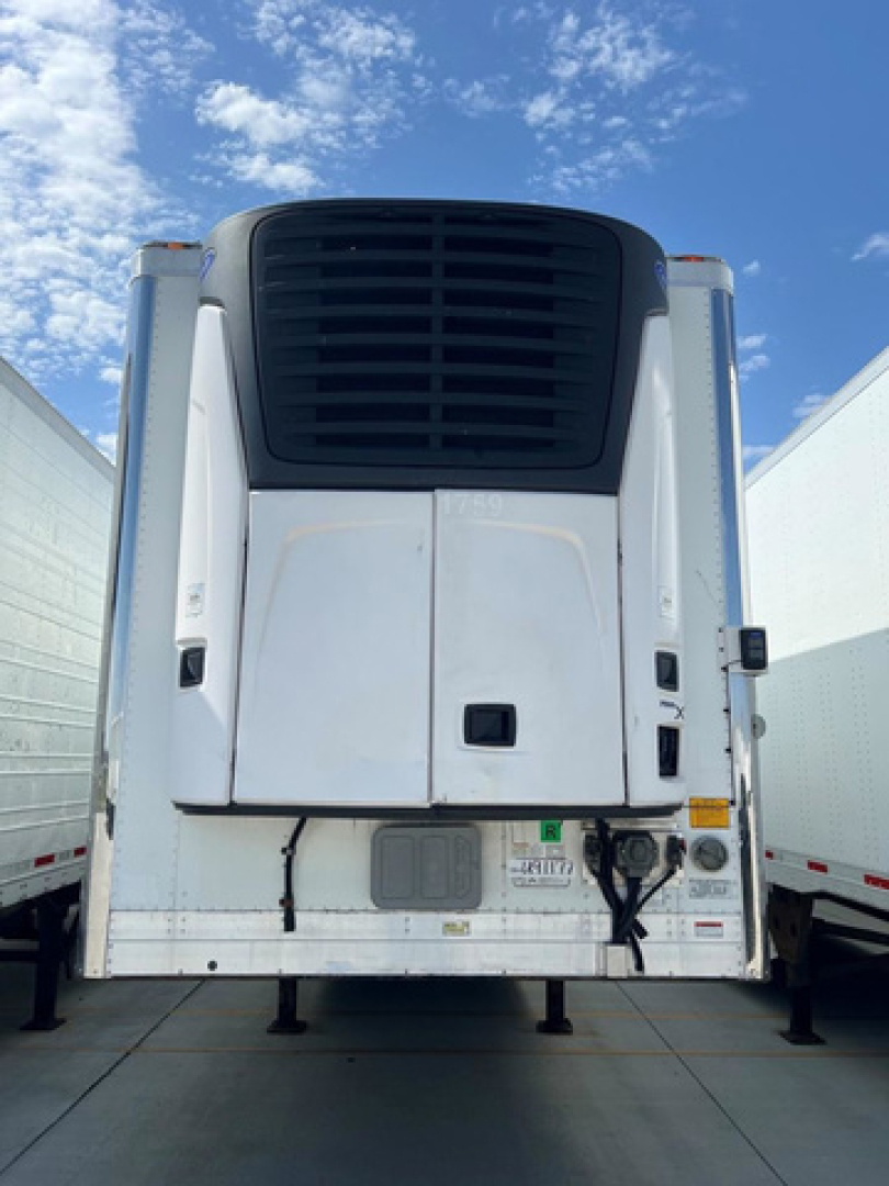 Trailer rear view of a 2021 Utility reefer with a black refrigeration unit grille and white body panels.