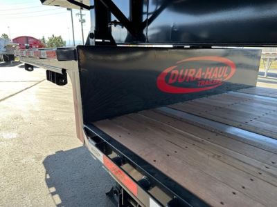 Drop deck trailer hitch area showing Dura-Haul logo on side, wooden deck, black painted frame and edge guards.