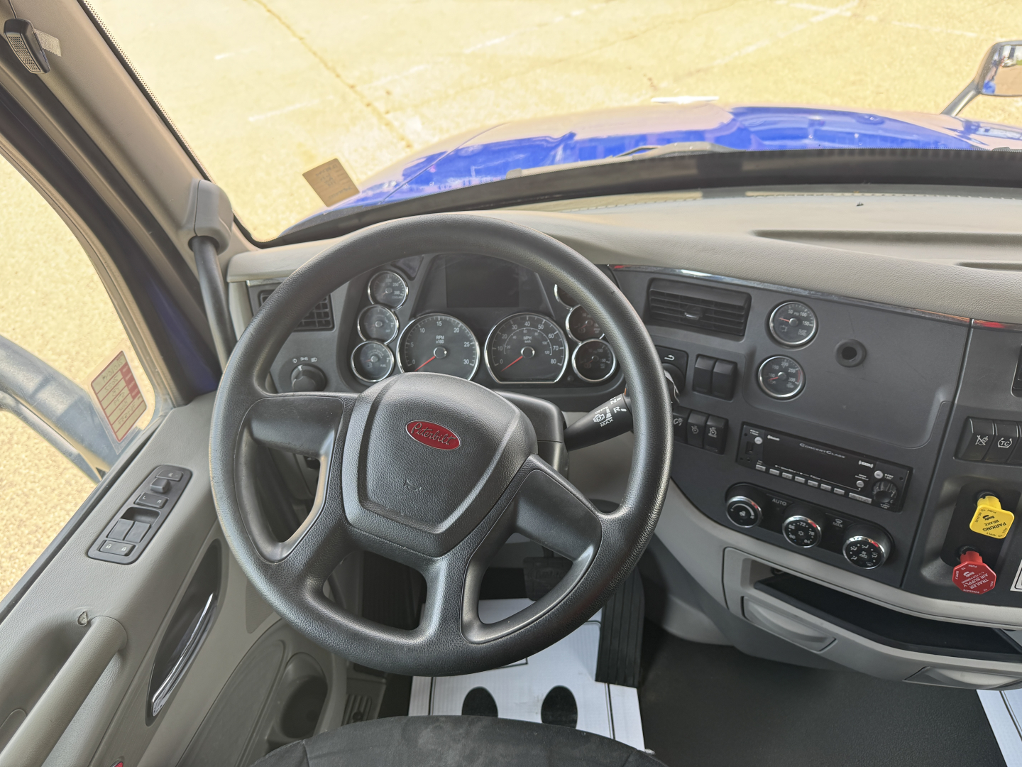 Peterbilt 579 cab interior showing steering wheel dashboard gauges and controls