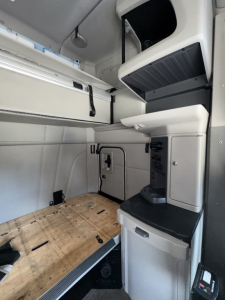 Peterbilt 579 truck cab interior showing sleeper area and cabinetry with storage compartments.