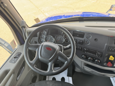 Peterbilt 579 cab interior showing steering wheel dashboard gauges and controls
