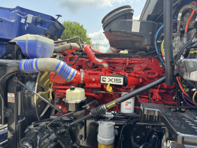 Peterbilt 579 engine bay showing Cummins X15 engine block and auxiliary components.