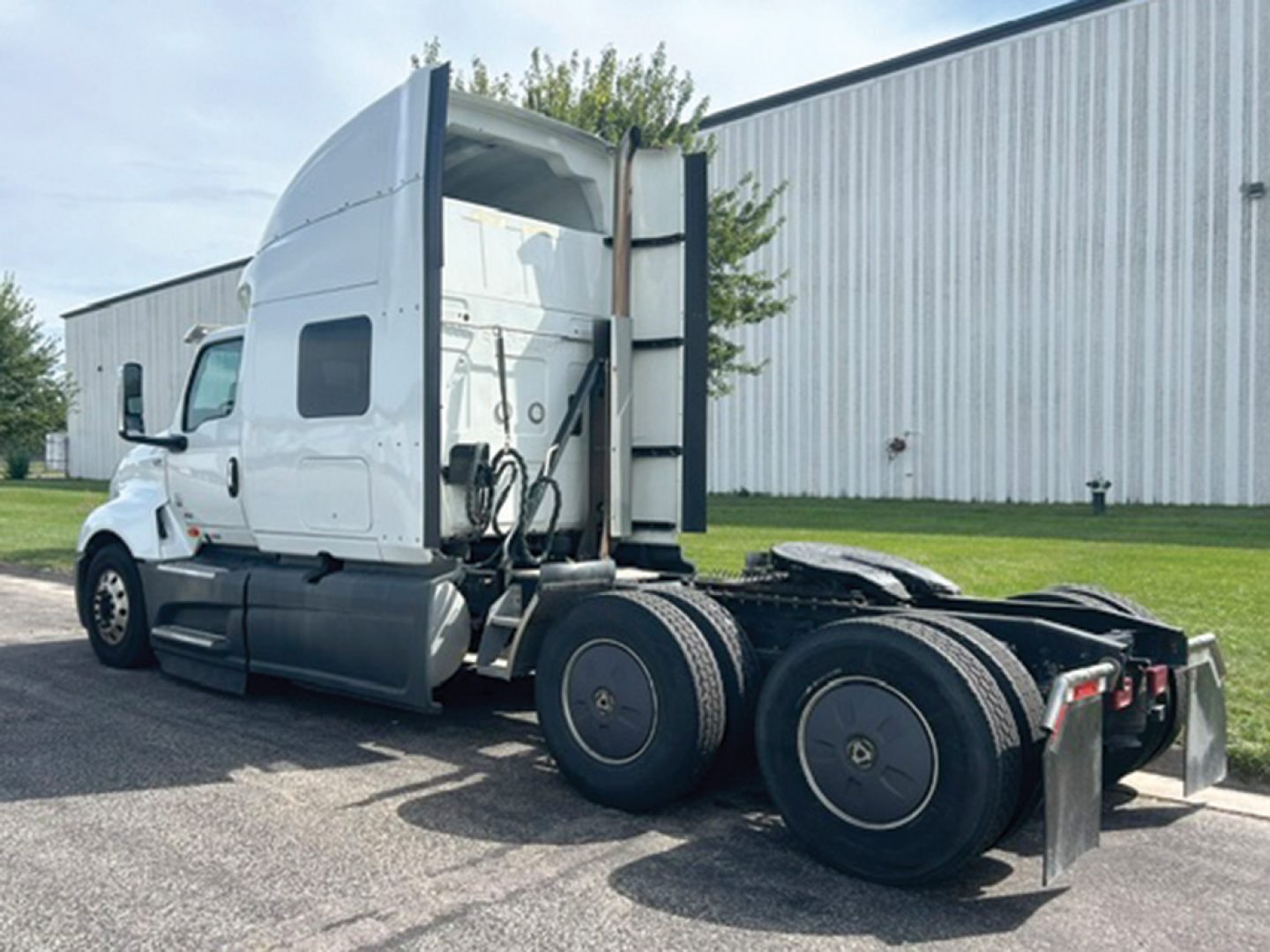 International LT625 tractor showing side/back view with sleeper cab and five-wheel tandem, no visible text on decals.