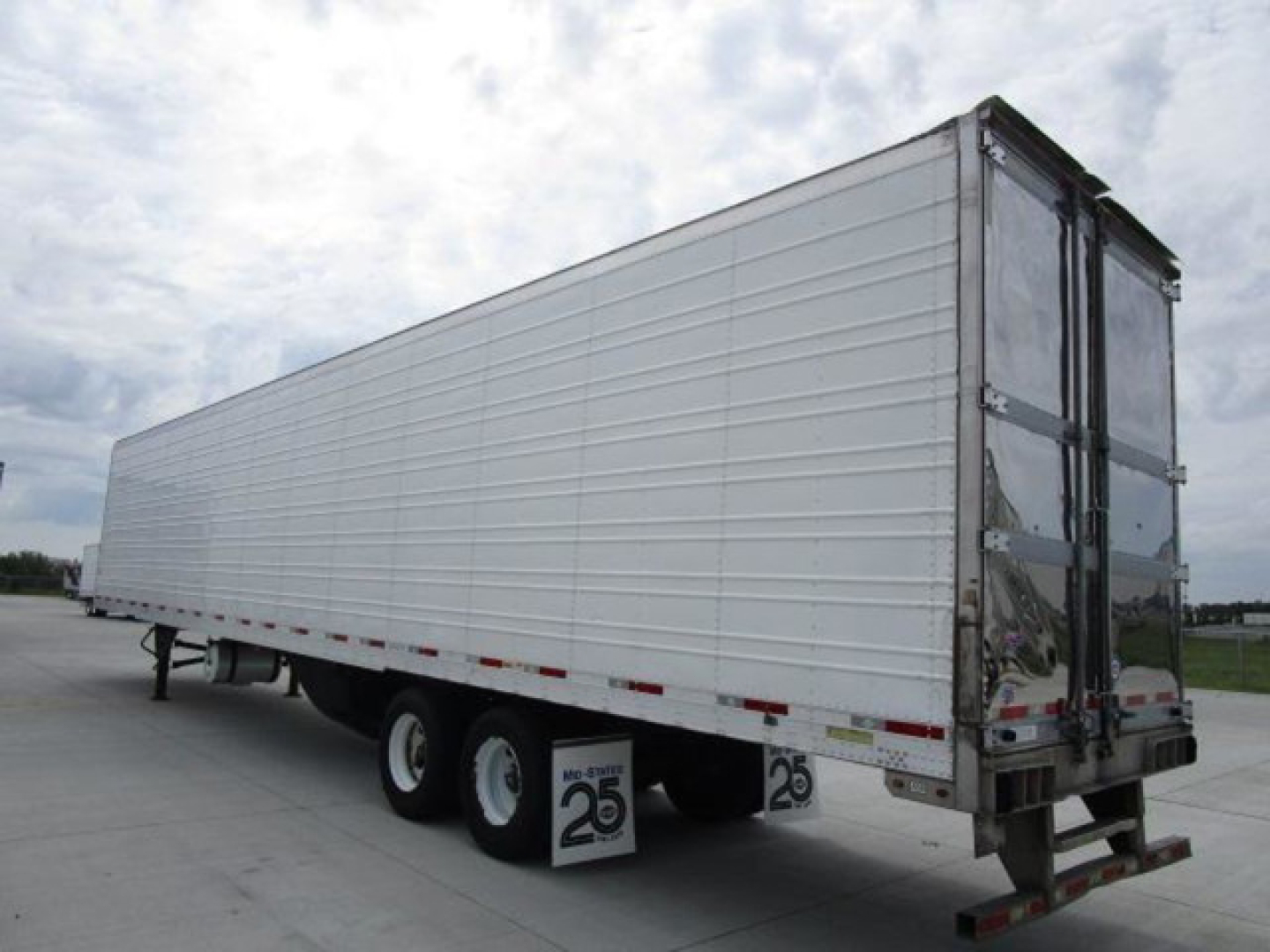 Trailer showing a 2019 utility reefer with white side panels and double rear doors, side-view of a refrigerated trailer with tandems and stock numbers visible.