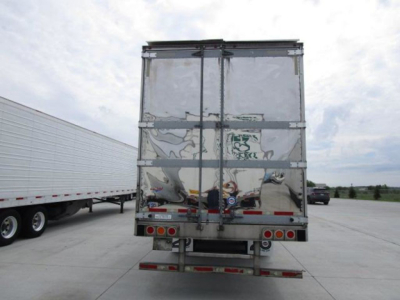 Rear view of a 2019 Utility reefer trailer showing double rear doors with metal framing, reflective silver surface, and bumper with taillights.
