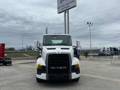 Truck front view of a white 2026 Mack PR64T daycab showing headlights and grille with Mack lettering.