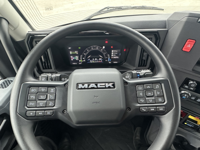 Mack PR64T interior view of steering wheel with dashboard and instrument cluster visible.