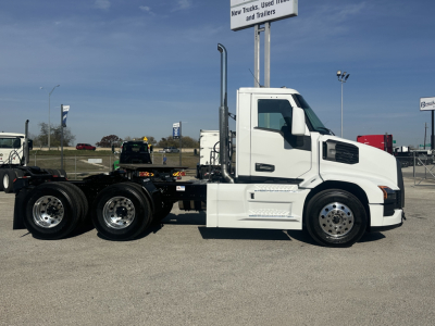 Truck chassis showing 6x4 Mack PR64T cab and white exterior with dual rear axles and chrome wheels.