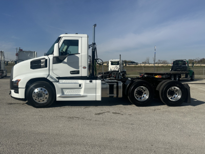 Mack PR64T conventional daycab tractor in white, side profile showing sleeper cab, dual rear axles, chassis, and steps.