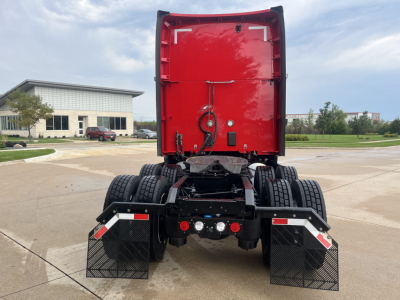 Kenworth T680 tractor rear view showing fifth wheel clearance, bumper steps, and rear mud flaps.