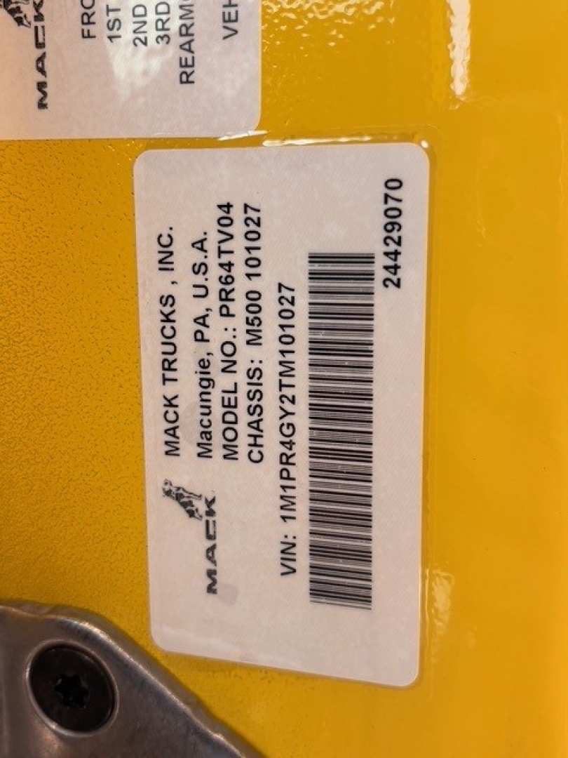 Mack trucks label showing manufacturer and model details with VIN and stock number.