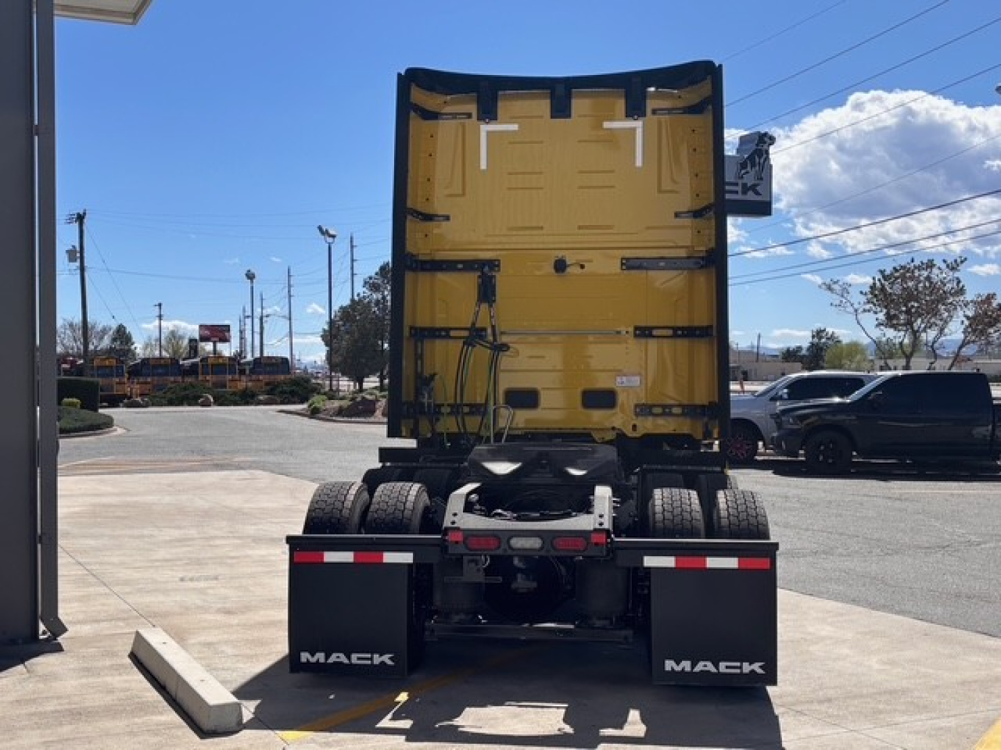 Mack PR64T76H truck rear view showing fifth wheel area and dual rear wheels with Mack mud flaps.