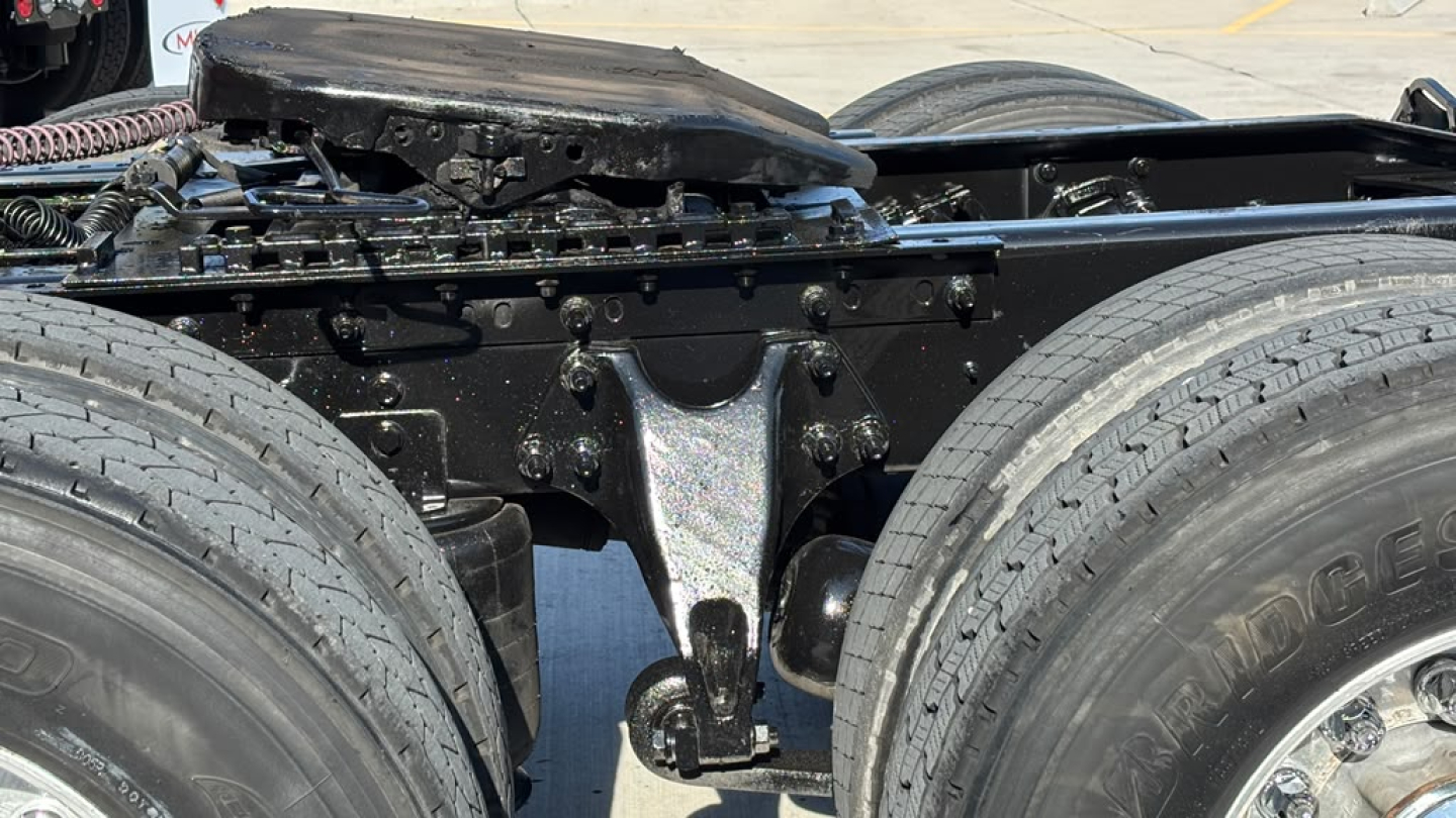 Truck chassis area with dual rear axles and suspension components visible under a 2022 International LT625 listing.
