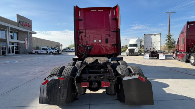 Truck chassis rear view showing fifth wheel, dual rear axles, mud flaps, and wiring harnesses for a 2022 International LT625.