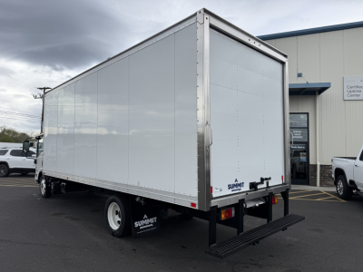 Box truck rear and side view with Isuzu NQR, aluminum cargo trailer, Summit rear stairs, white cargo body, black chassis, dock area background.