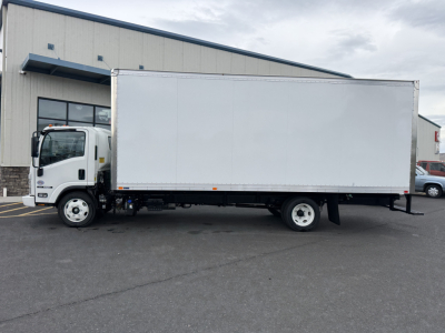 Isuzu NQR box truck side view showing cargo box and cab in a dealership lot.