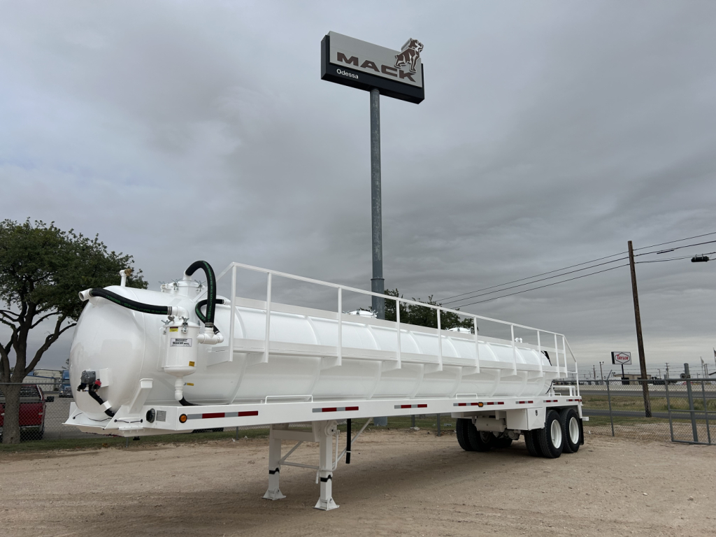 Trailer-mounted vacuum tanker (2026 Troxell 130BBL) showing cylindrical white tank on a dual-axle trailer with rear stair railing and undercarriage supports.