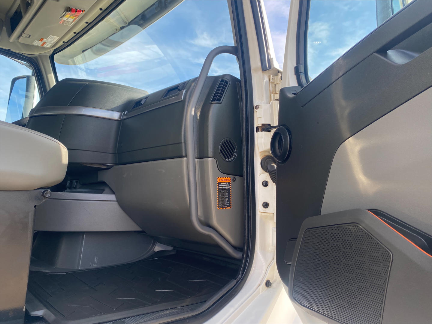 Volvo VHD84F200 truck cabin interior view from driver side door open showing dashboard and seating area