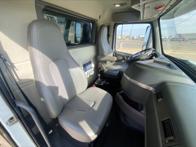 Interior of Volvo VHD truck cab showing steering wheel, driver seat, and dashboard with center console and digital display.