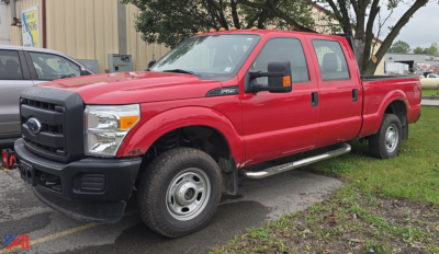 Ford F-250 Super Duty pickup truck in red, crew cab, single rear wheel, side view showing front grille and bumper and running boards.