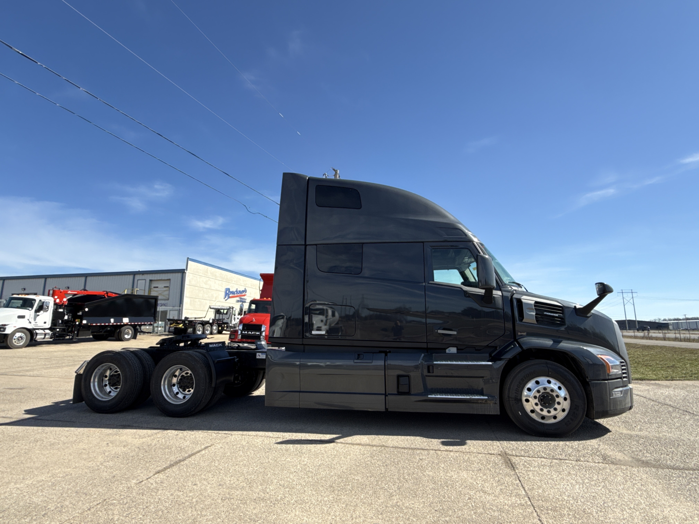 Mack PR64T76H semi-truck tractor side profile showing sleeper cab and dual rear axles.