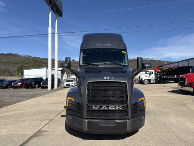 Conventional sleeper truck front view showing Mack PR64T76H with large grille, headlights, and bold MACK lettering.