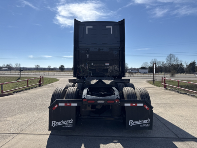 Rear view of a Mack PR64T76H tractor tractor chassis showing dual rear axles, fifth wheel, and mud flaps with Bruckner’s logos.