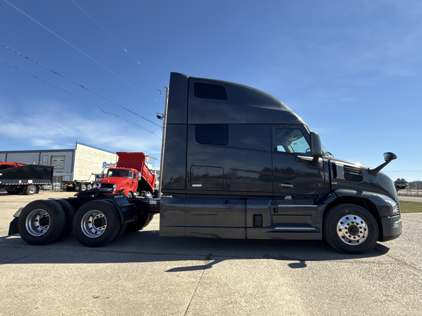 Mack PR64T76H conventional sleeper truck side view showing cab and dual rear axles.
