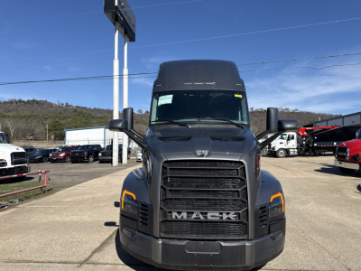 Front view of 2026 Mack PR64T76H truck with large grille and headlights in a dealership lot.