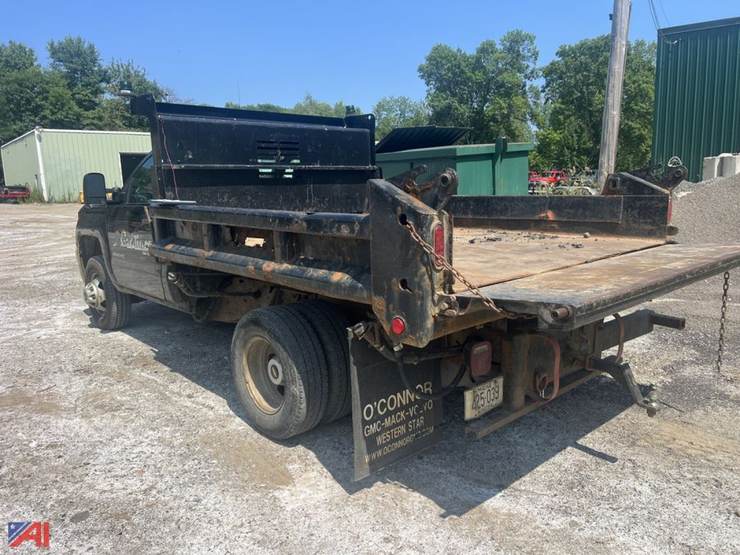 Dump truck bed with Chevrolet Silverado 3500HD chassis in-service showing rear and side view with dump bed rails and hitch.