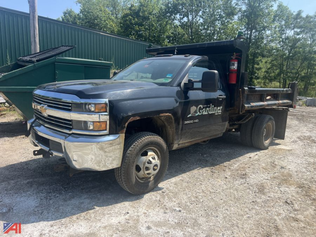 Chevrolet Silverado 3500HD CC Dump Truck in-service with dump bed and logo on door, front chrome bumper, dual rear wheels, dump body, and side marker text.